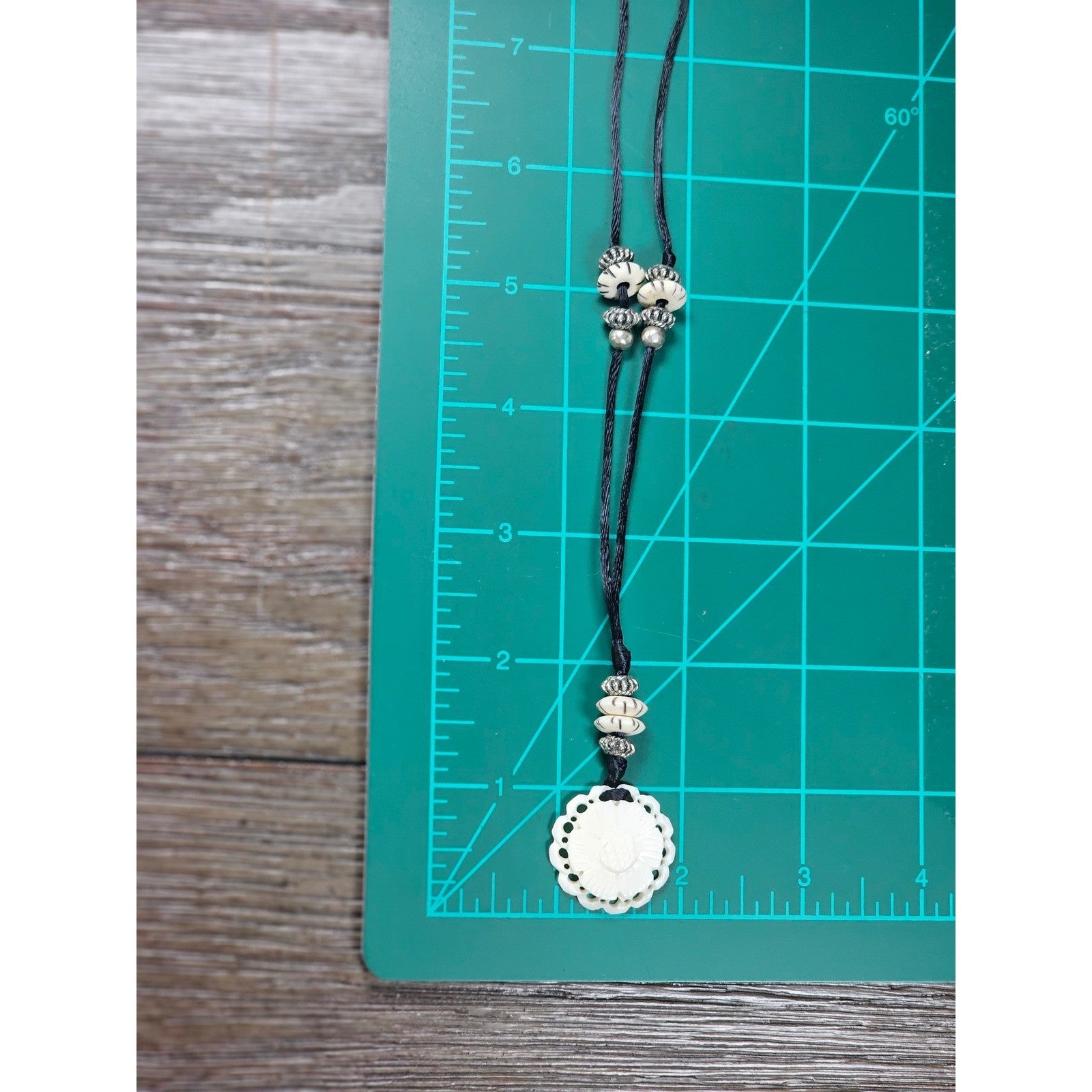 Vintage Carved Floral Pendant Necklace on Black Cord