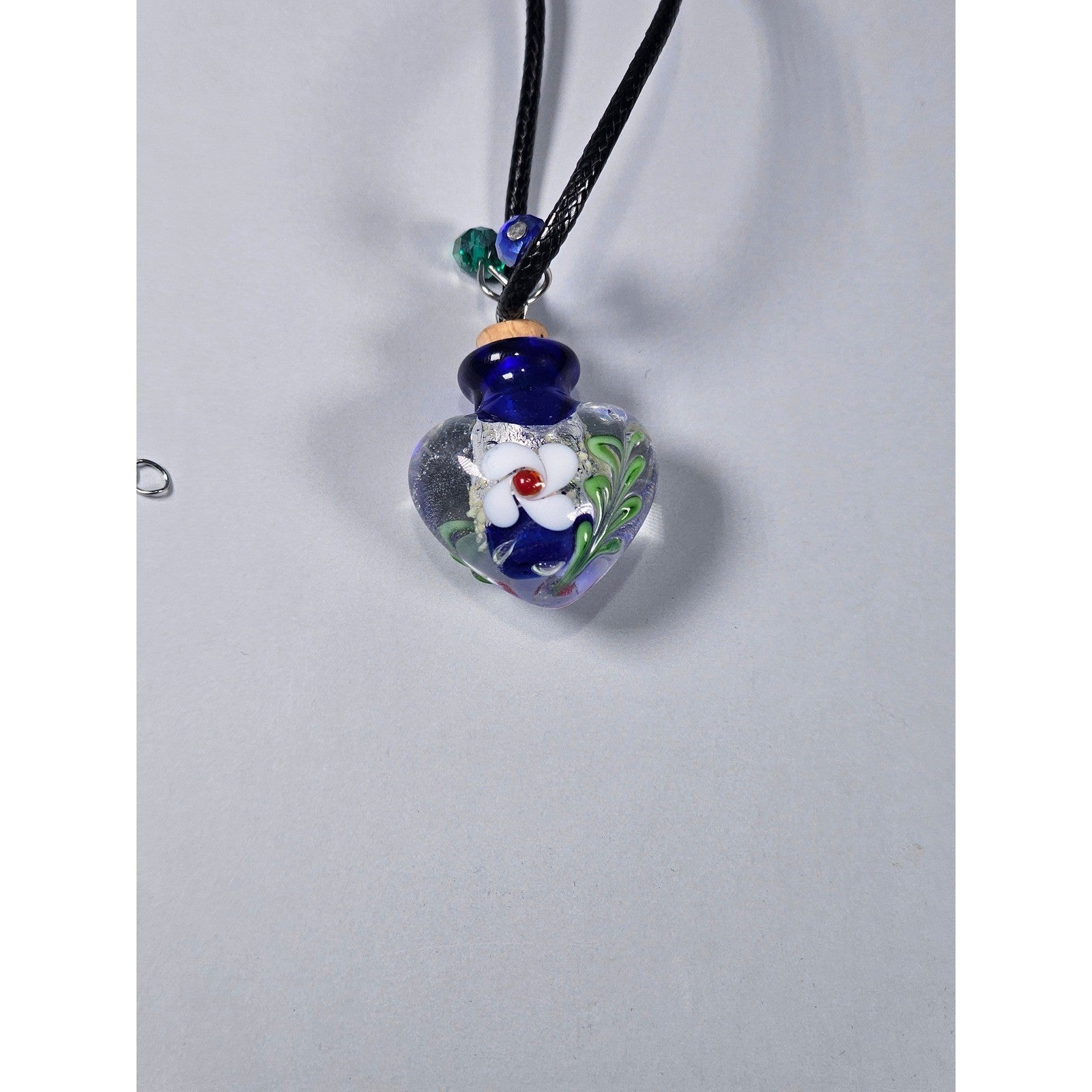 Glass Heart Bottle Pendant Necklace with Floral Design on Black Cord