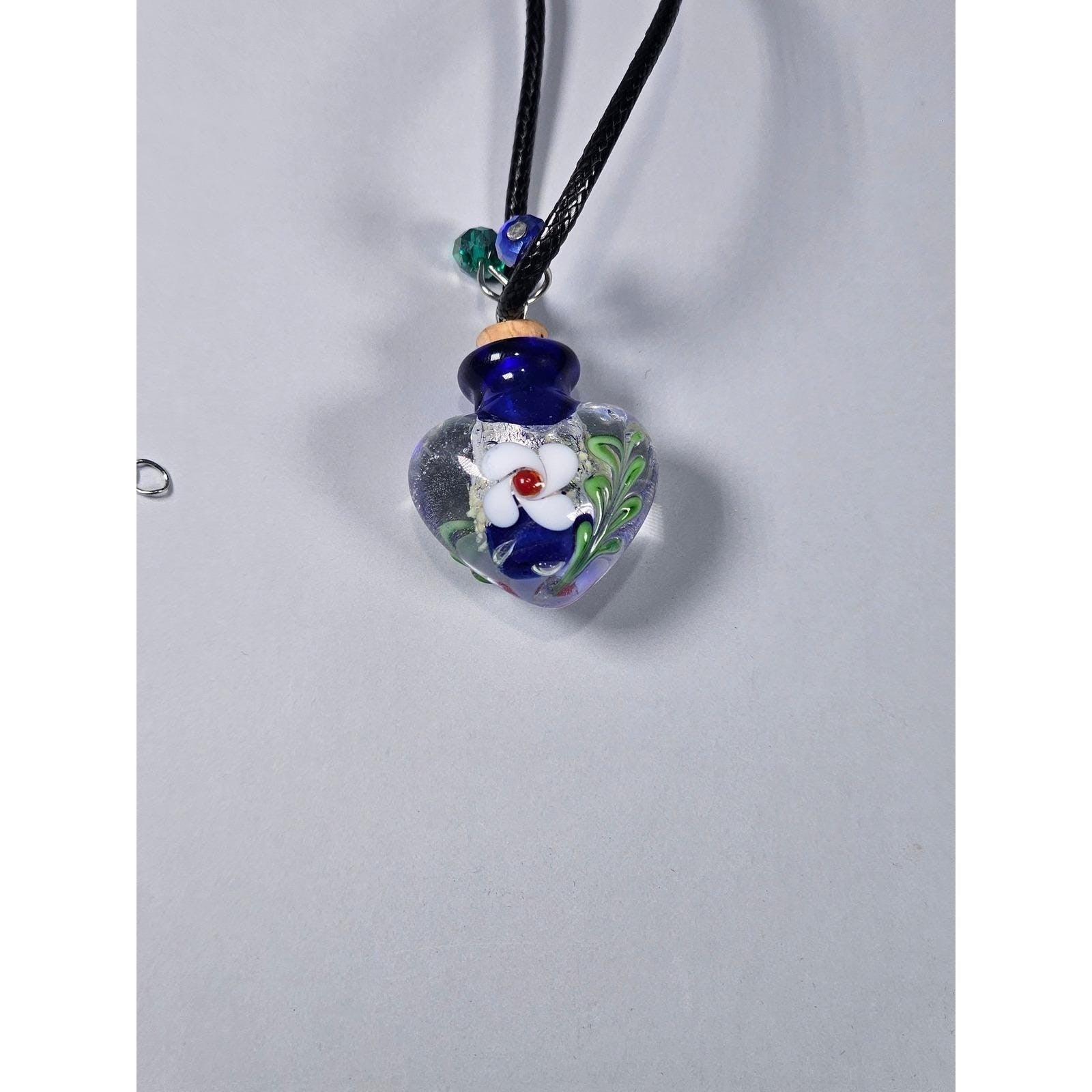 Glass Heart Bottle Pendant Necklace with Floral Design on Black Cord