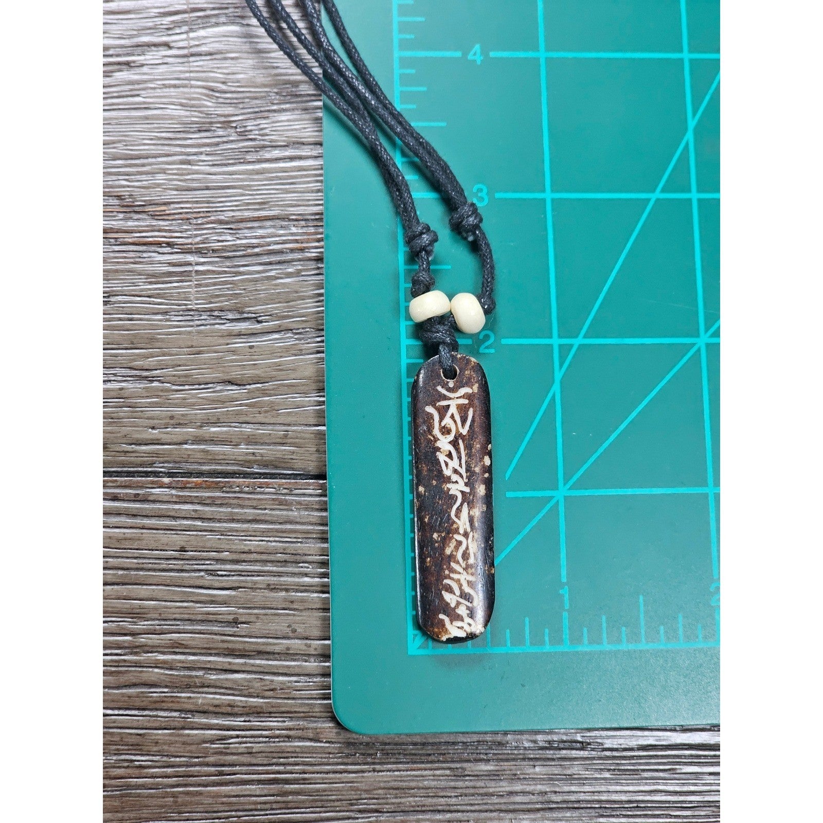 Vintage Carved Script Pendant Necklace Brown Cord